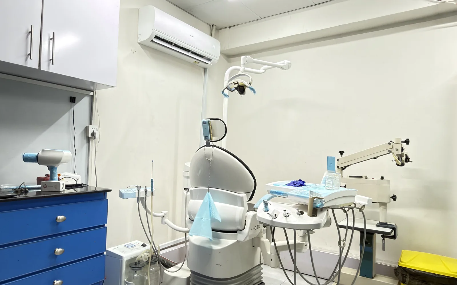 Treatment room with dental chair and equipment at Dr Hashim & Associates