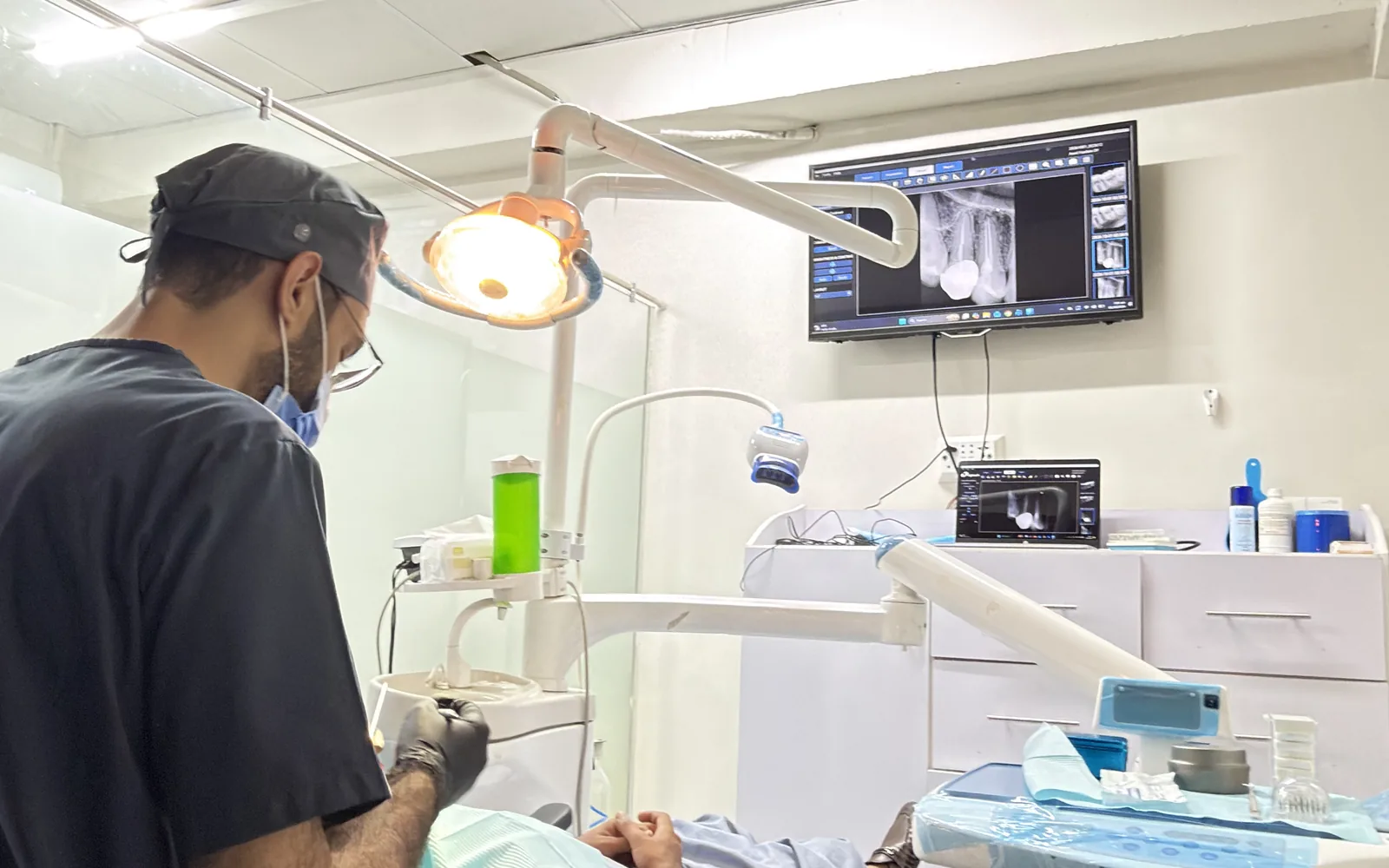Dentist treating a patient in a treatment room at Dr Hashim & Associates, G-9 Markaz